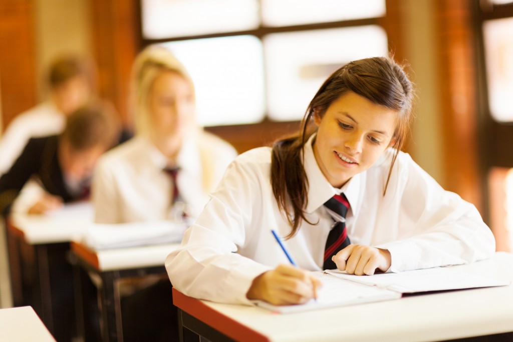 Student writing on her notebook