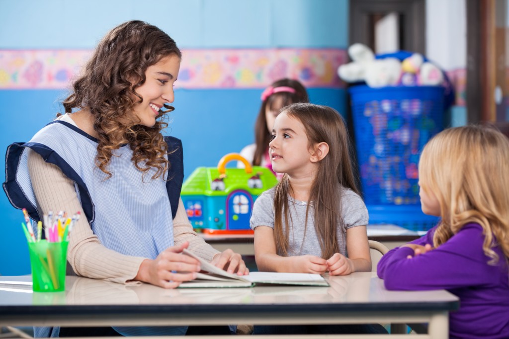 Child talking to her teacher