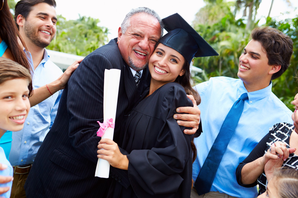 graduating student with her family