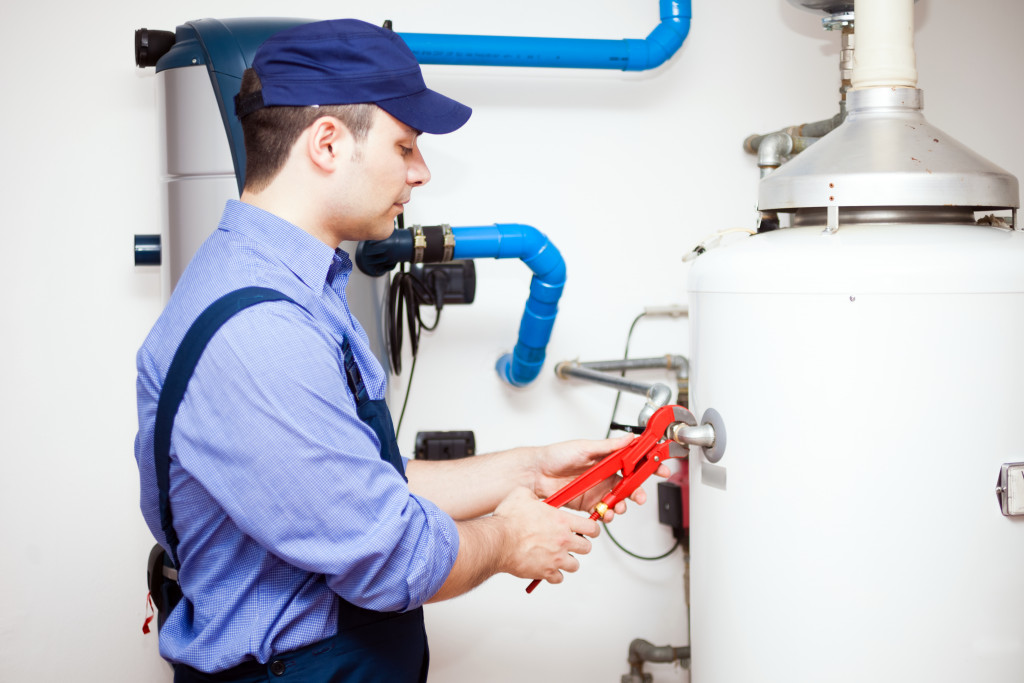 man inspecting water heater