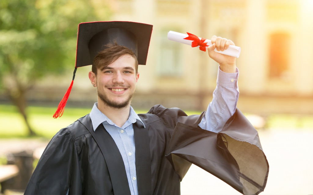 man holding his certificate