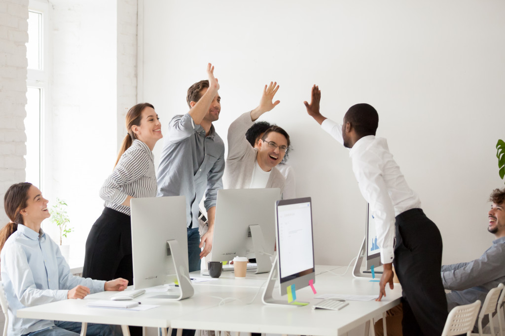 joyful employees giving a high five