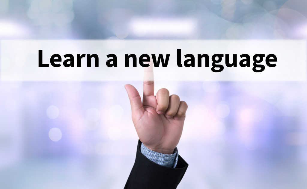 learn a new language with businessman pointing to button