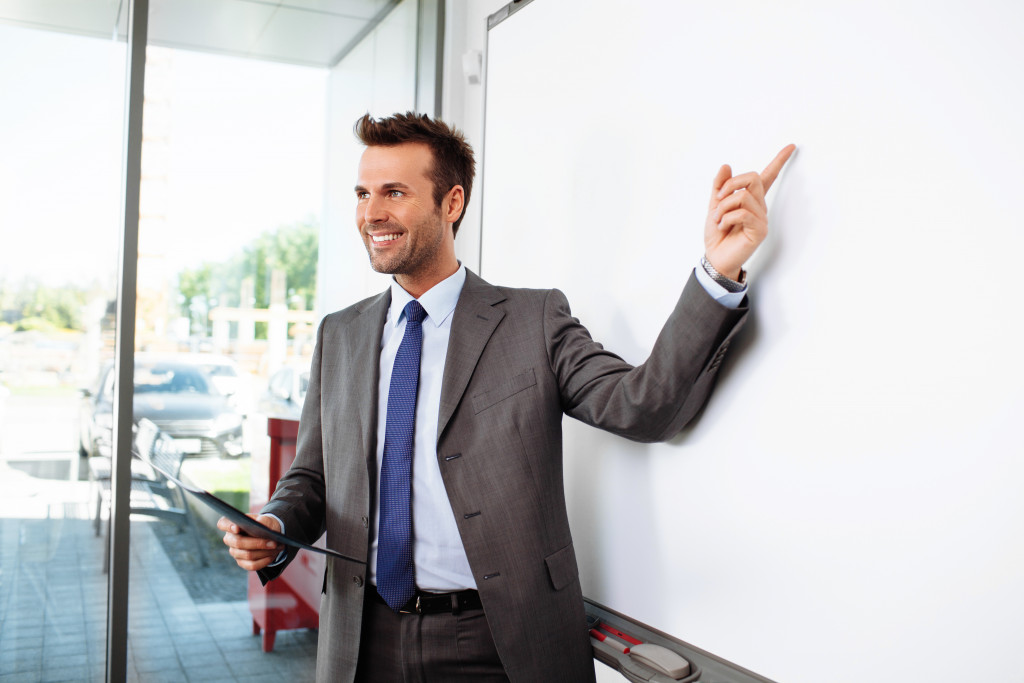 man pointing at the white board