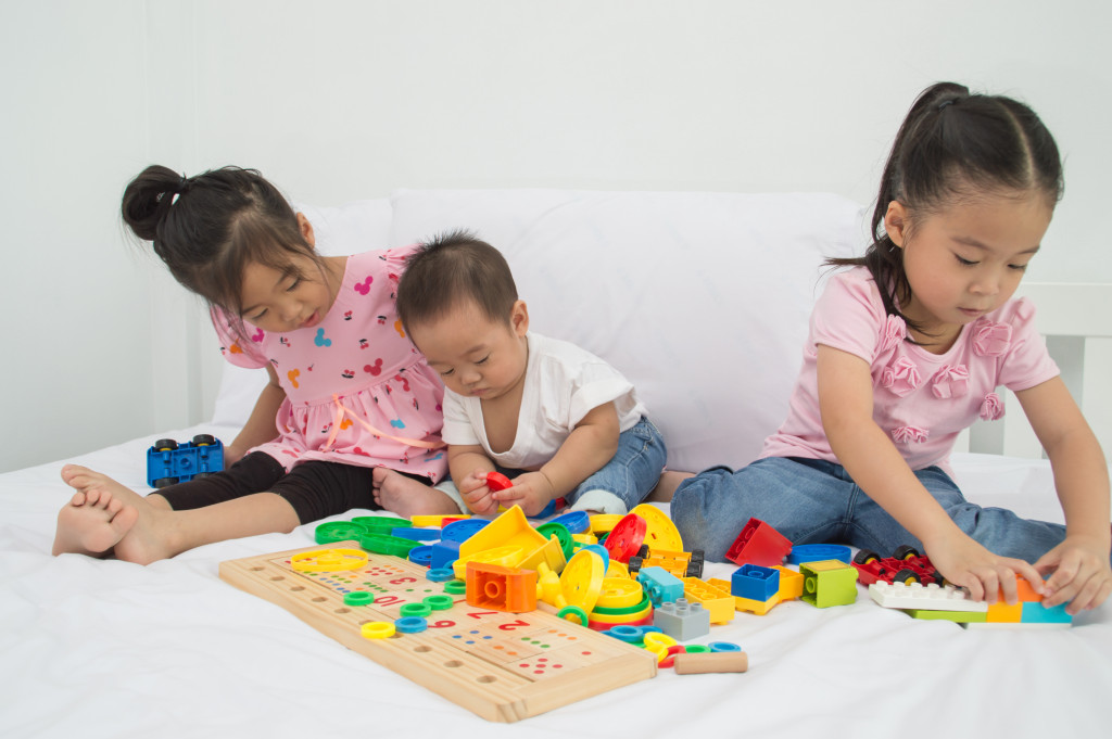 Little Children are playing in the playroom. 