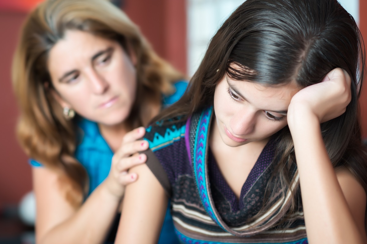 mother comforting her troubled daughter