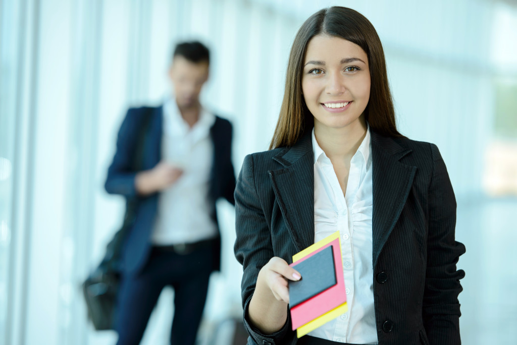 woman giving her visa and passport at the airport